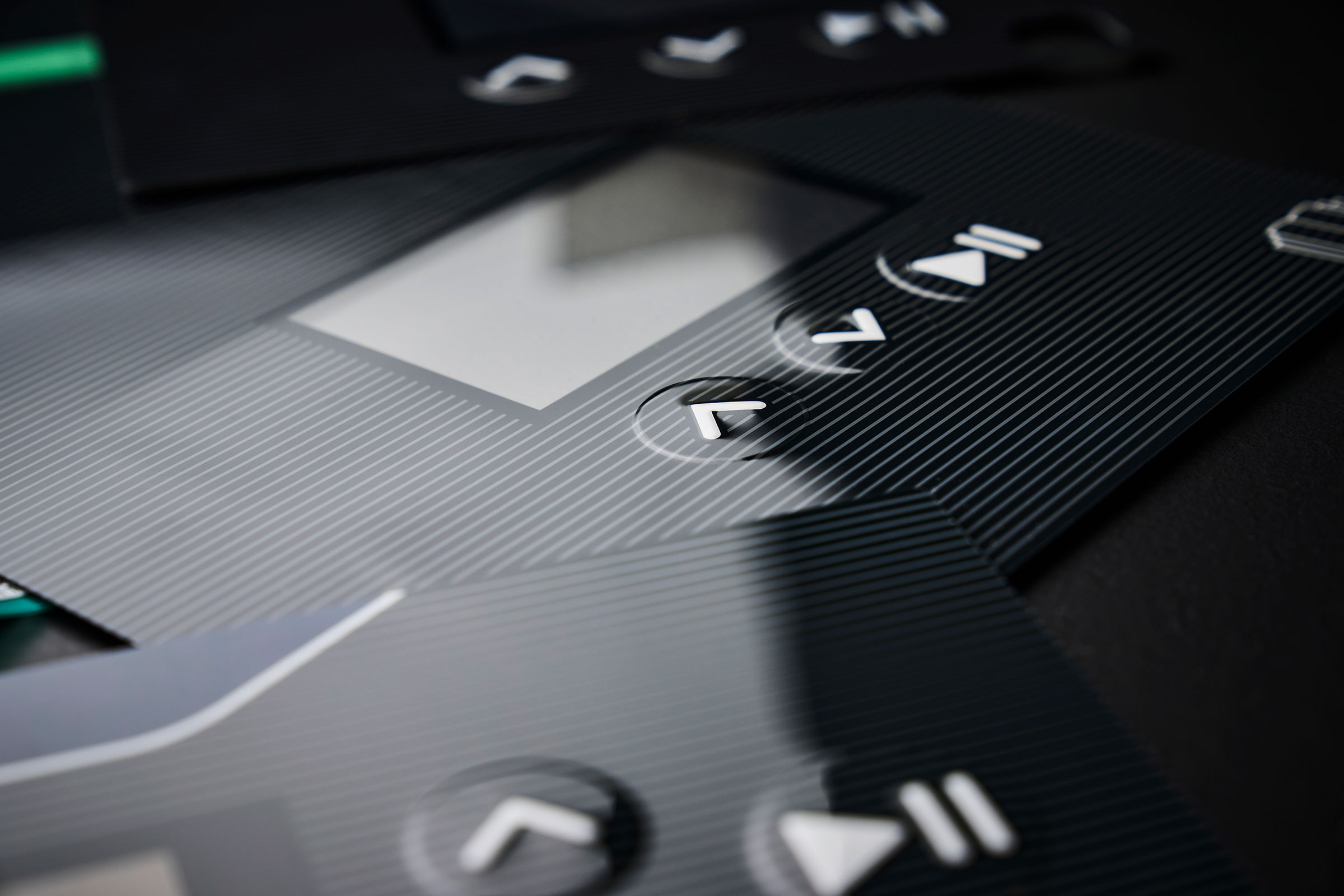 Membrane switch keypad with a high-gloss surface and double-embossed keys.